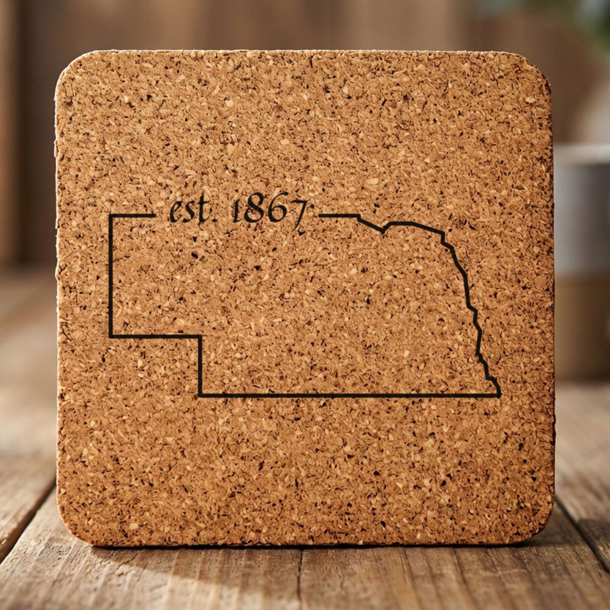 Nebraska square cork coaster engraved with the state outline and est. 1867