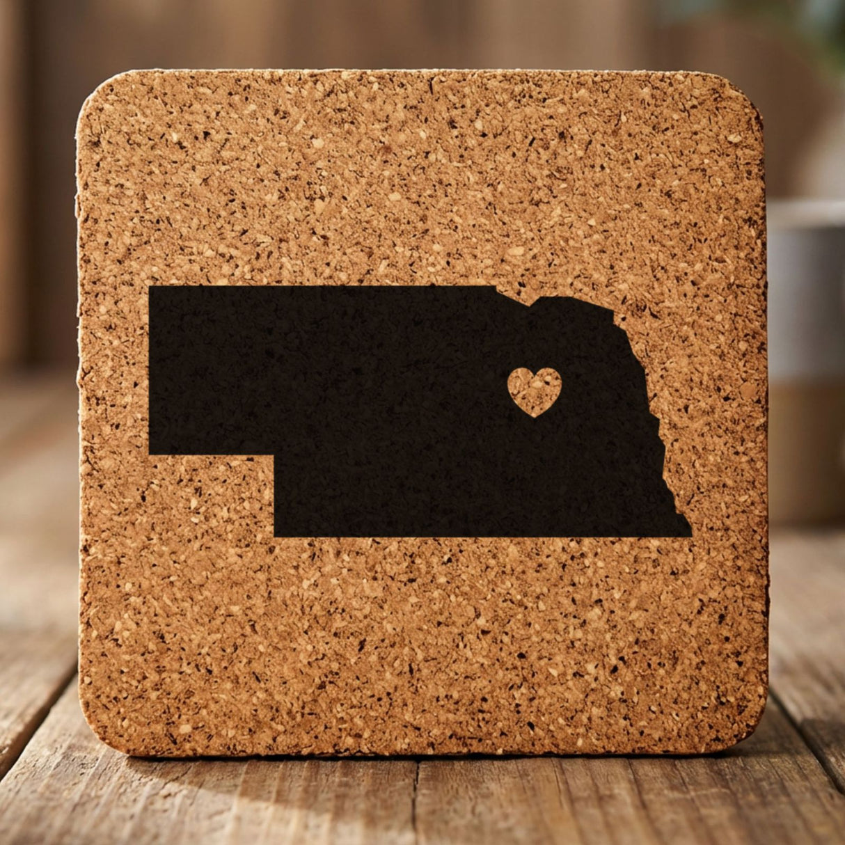 Nebraska square cork coaster engraved with the state shape and a heart