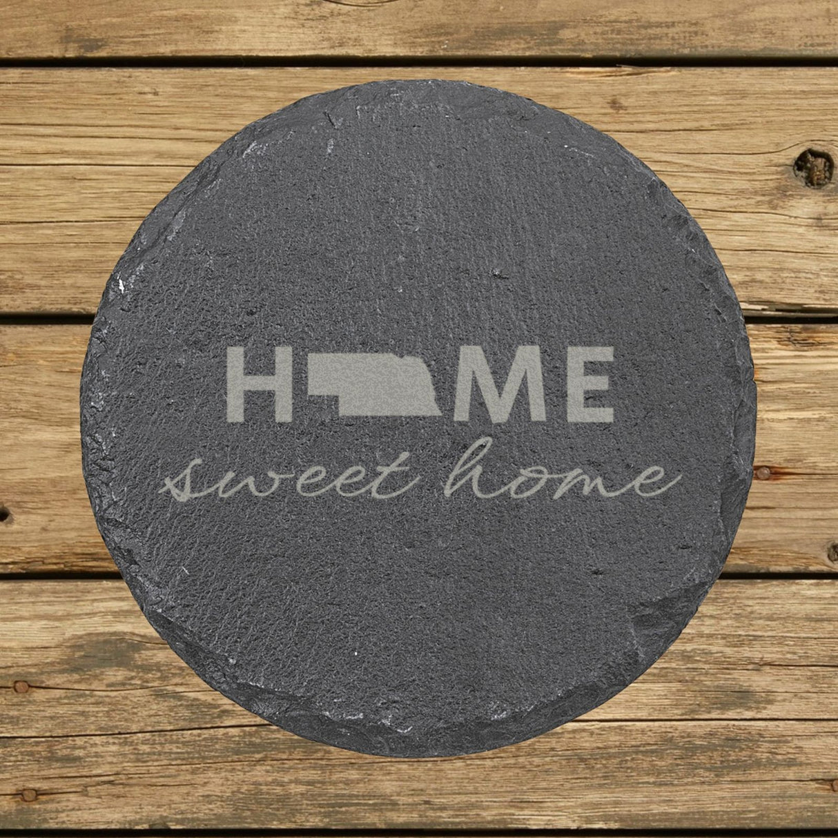 Nebraska round slate coaster engraved with HOME sweet home using the state shape as the letter O