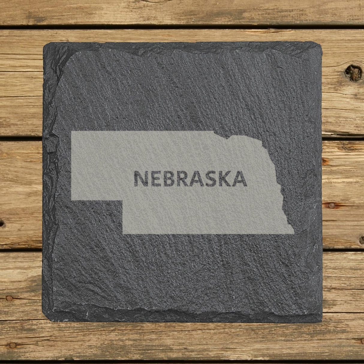 Nebraska square slate coaster engraved with the state shape and NEBRASKA in bold lettering