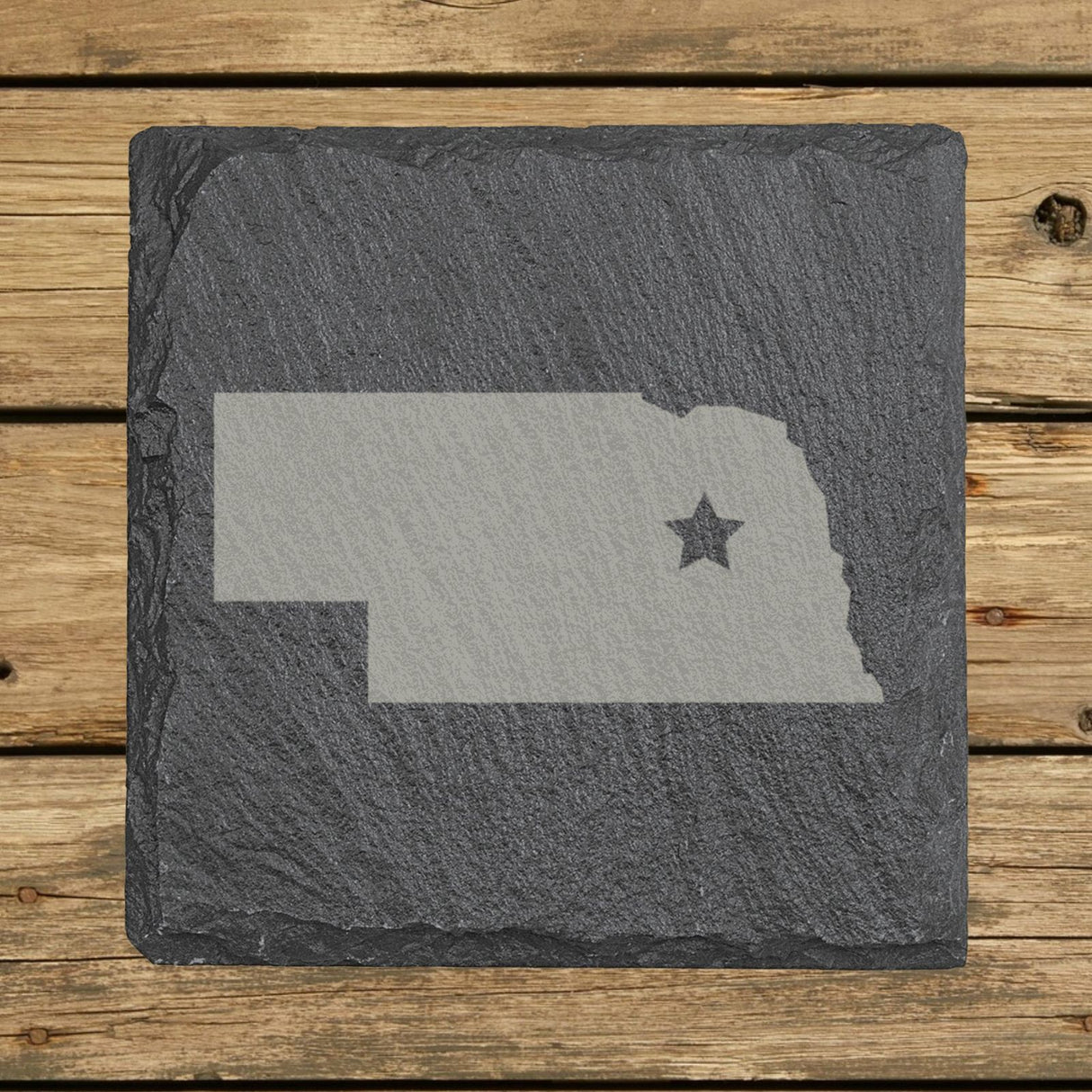 Nebraska square slate coaster engraved with the state shape and a star