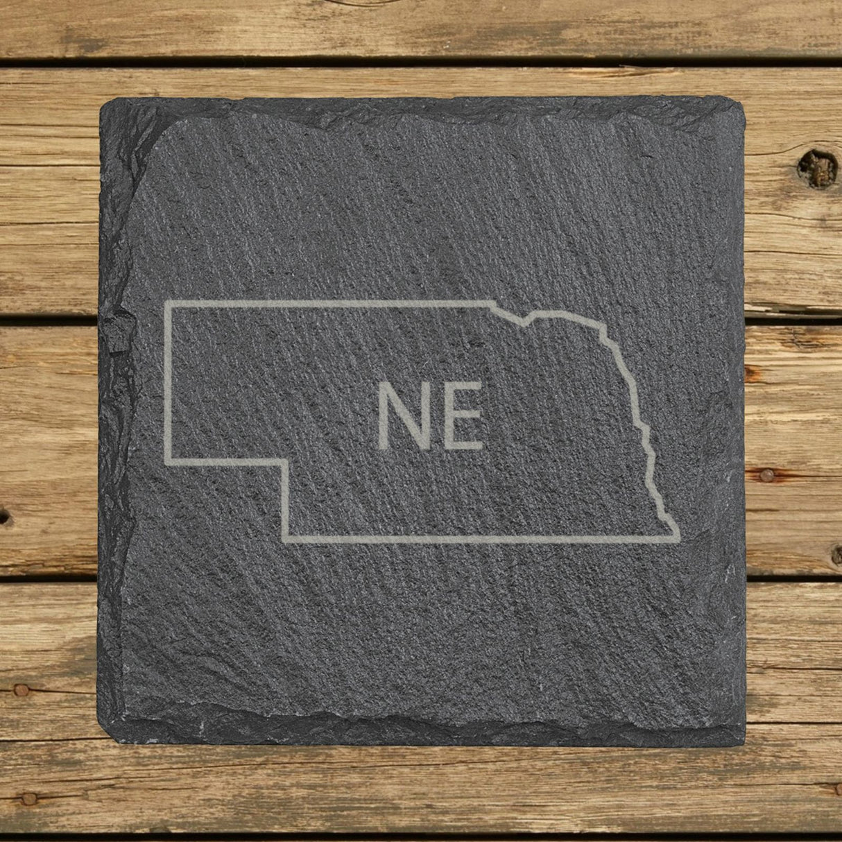 Nebraska square slate coaster engraved with the state outline and NE initials