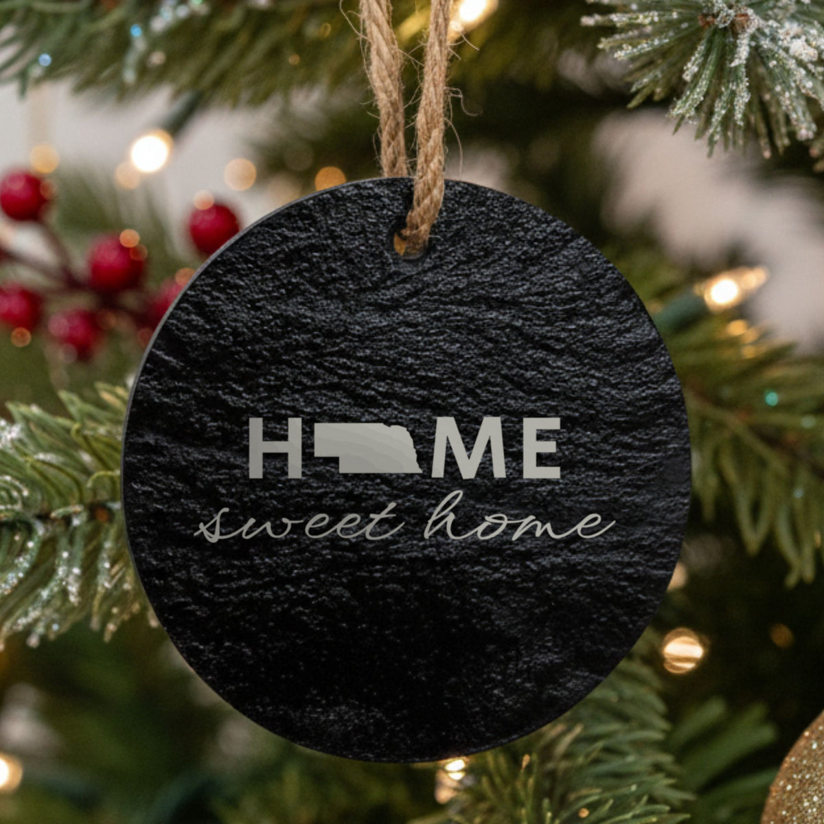 Nebraska round slate Christmas ornament engraved with HOME sweet home using the state shape as the letter O