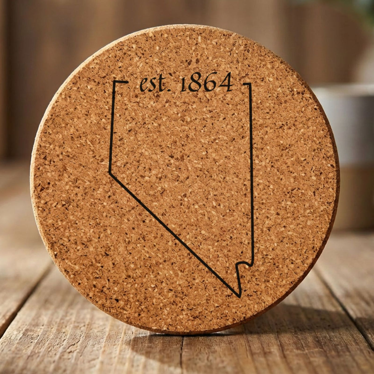 Nevada round cork coaster engraved with the state outline and est. 1864