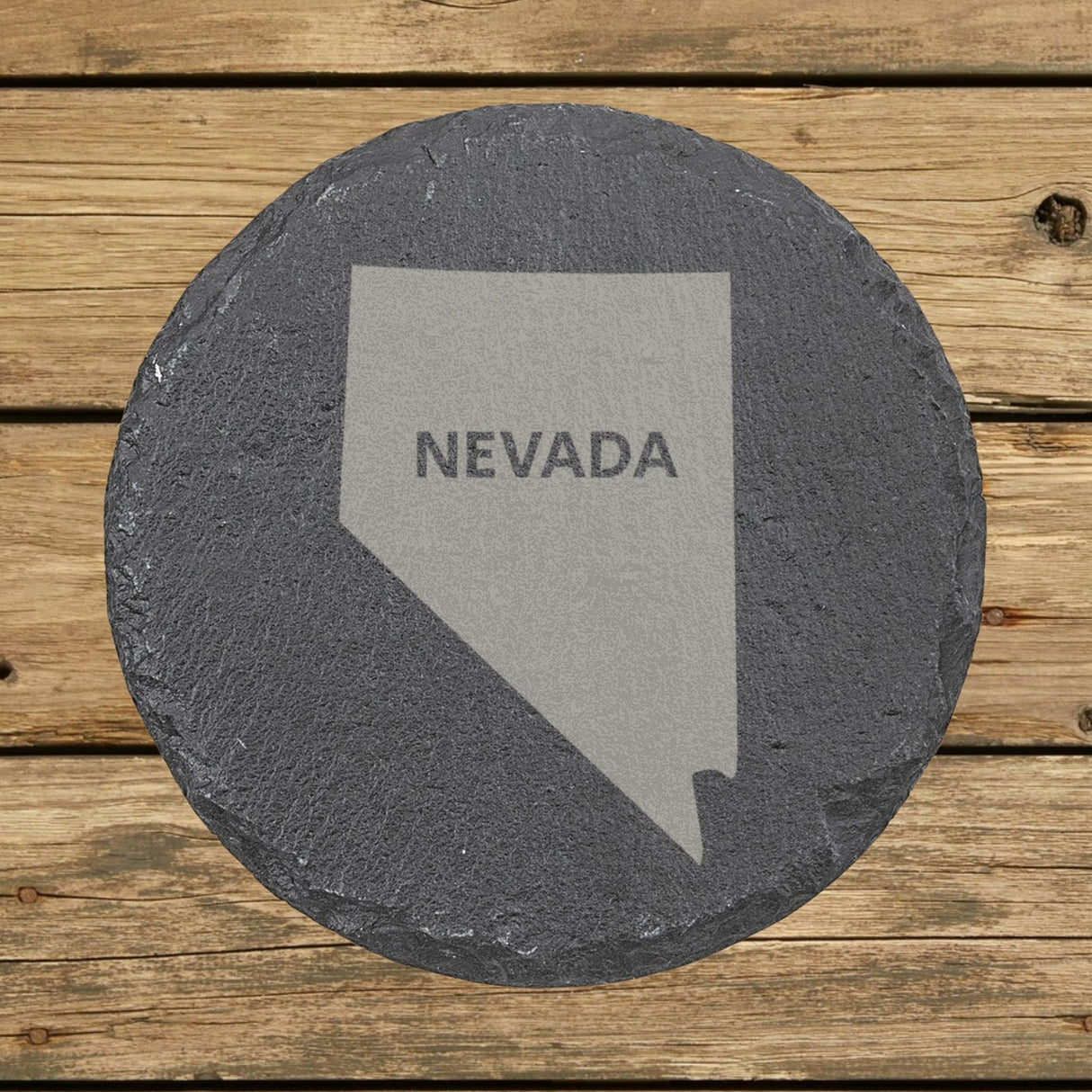 Nevada round slate coaster engraved with the state shape and NEVADA in bold lettering