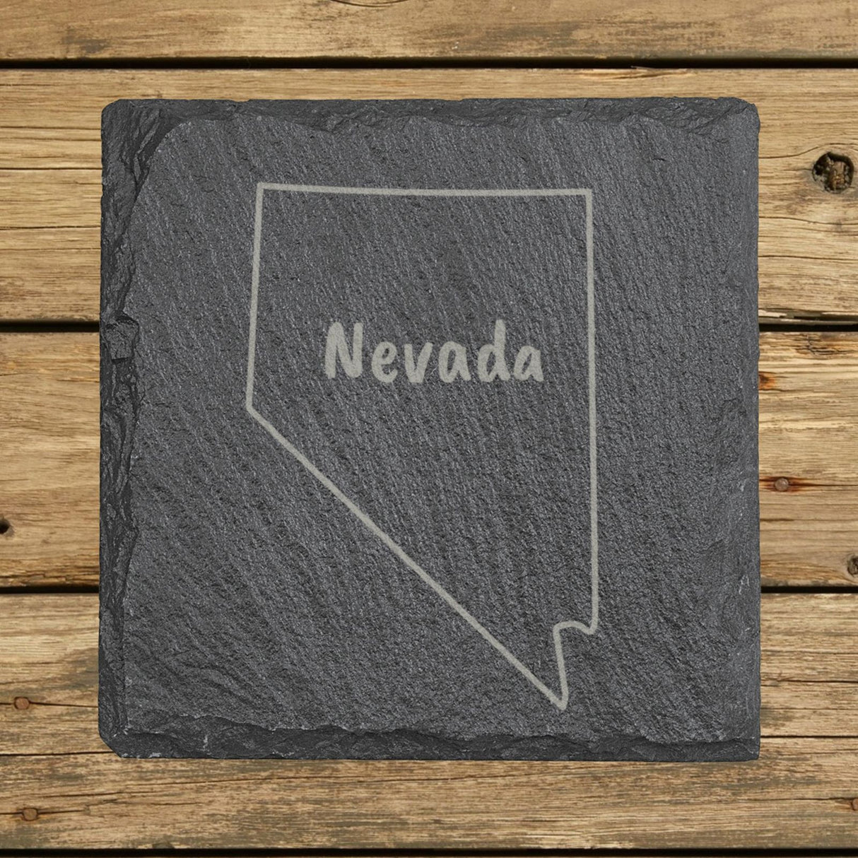 Nevada square slate coaster engraved with the state outline and NEVADA in hand-drawn brush lettering