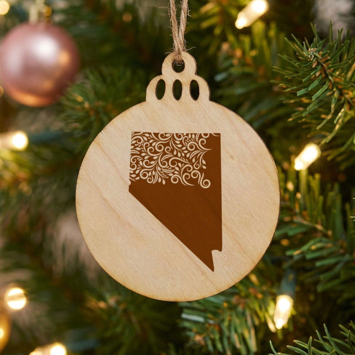 Nevada round wood Christmas ornament engraved with the state shape in ornate floral scrollwork