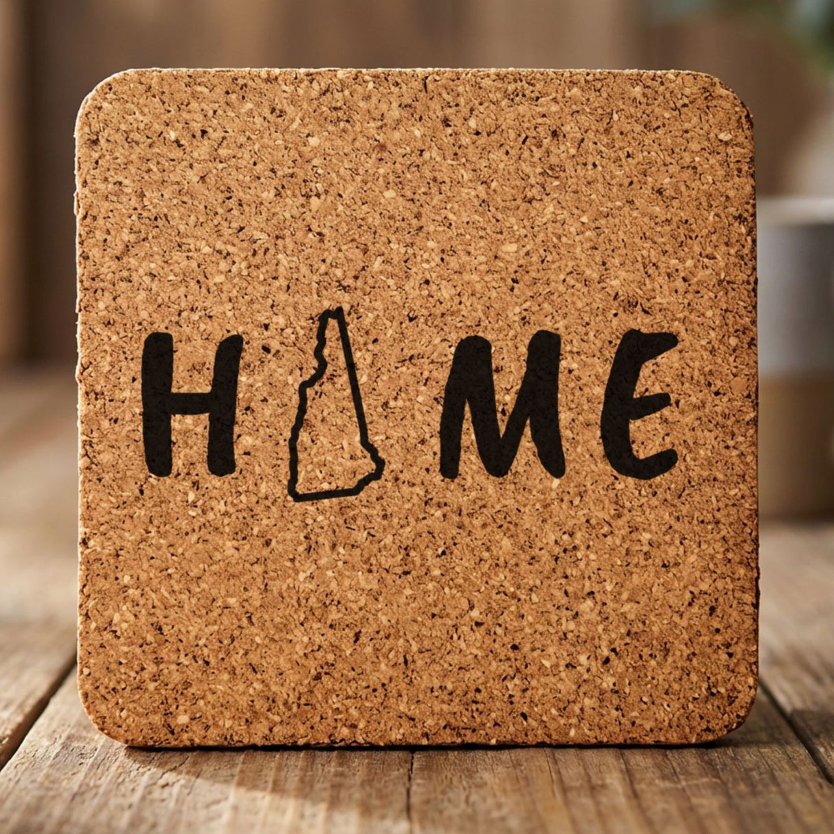 New Hampshire square cork coaster engraved with HOME using the state outline as the letter O