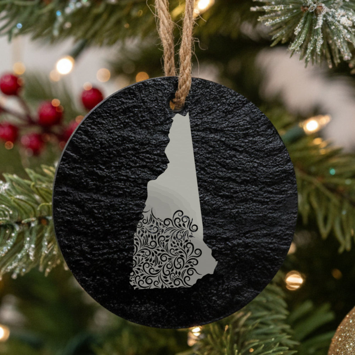 New Hampshire round slate Christmas ornament engraved with the state shape in ornate floral scrollwork