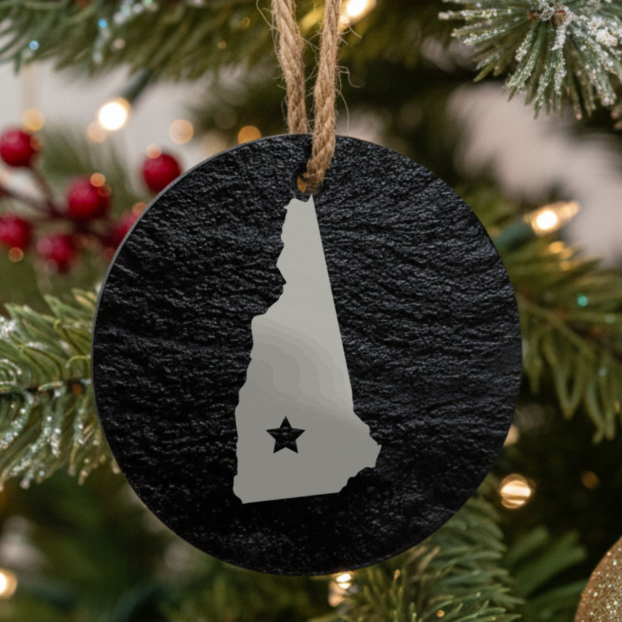New Hampshire round slate Christmas ornament engraved with the state shape and a star