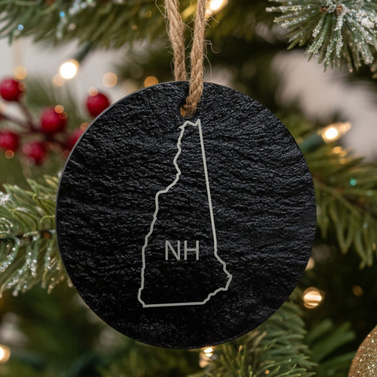 New Hampshire round slate Christmas ornament engraved with the state outline and NH initials