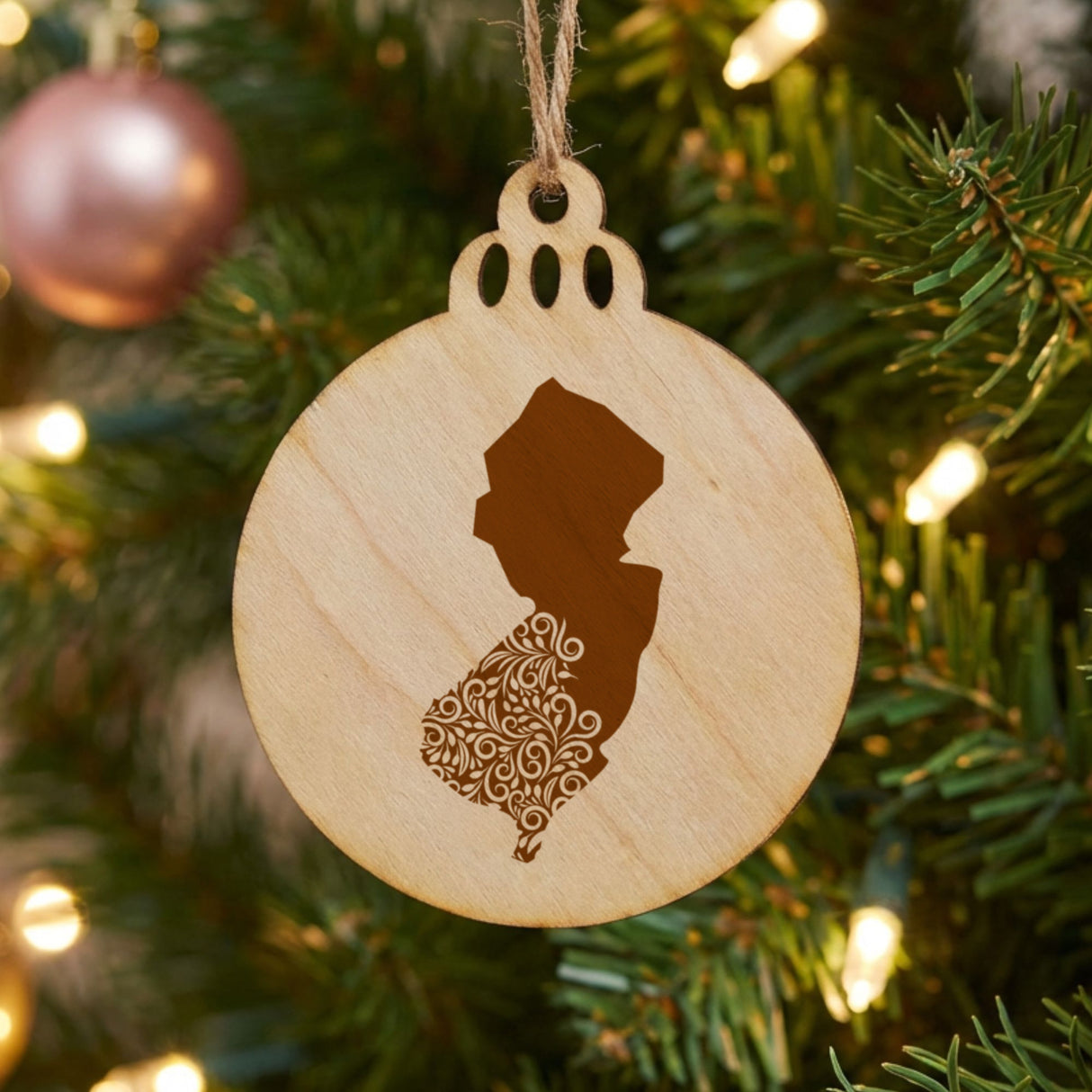 New Jersey round wood Christmas ornament engraved with the state shape in ornate floral scrollwork