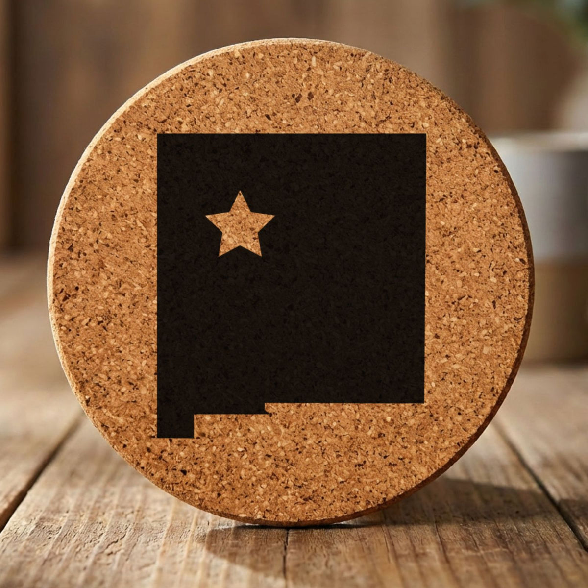 New Mexico round cork coaster engraved with the state shape and a star