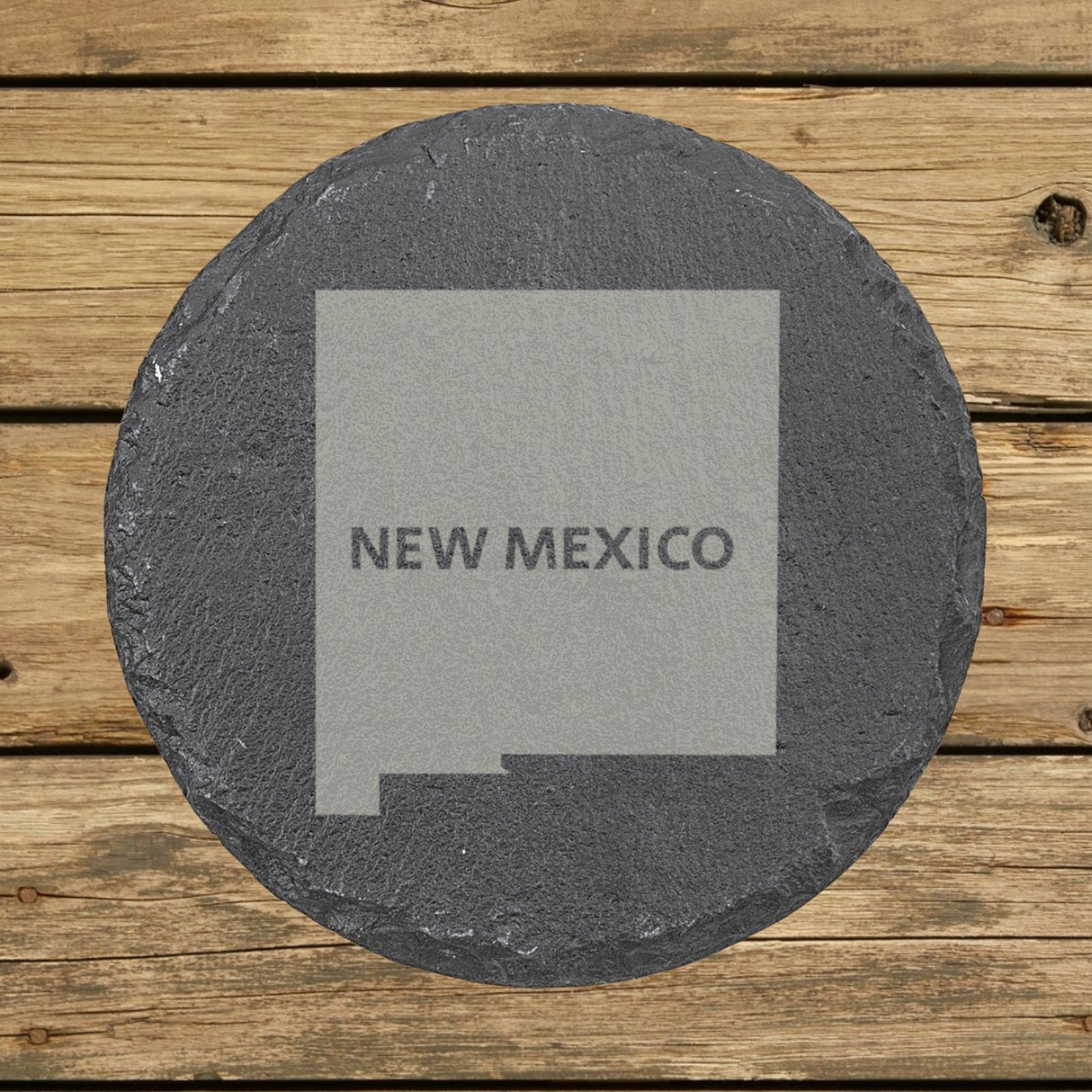 New Mexico round slate coaster engraved with the state shape and NEW MEXICO in bold lettering