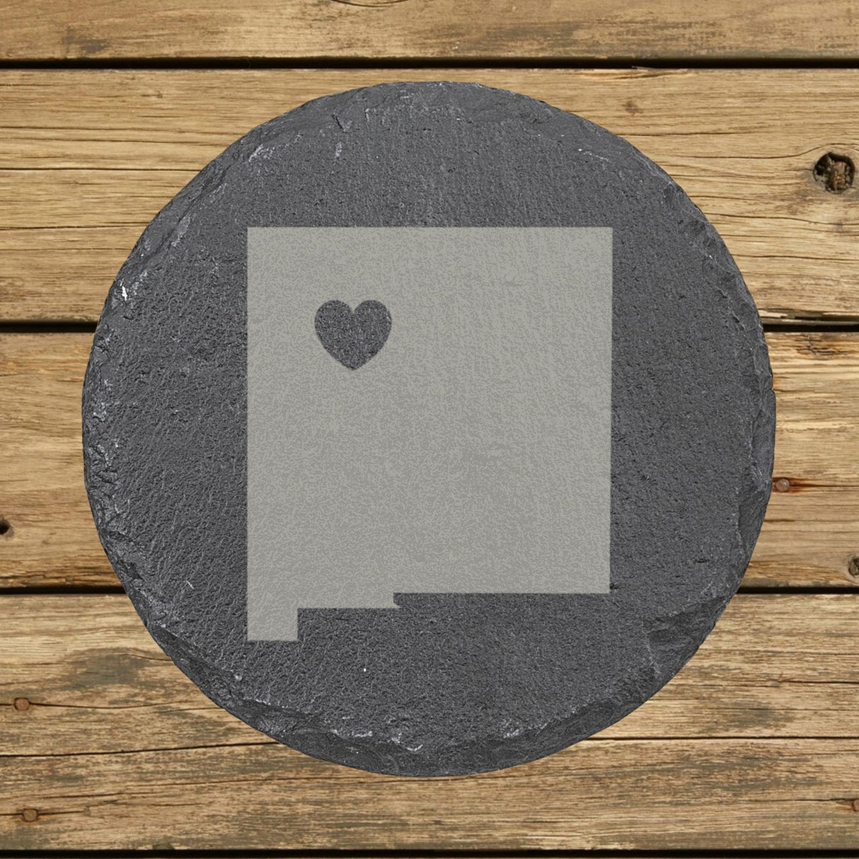 New Mexico round slate coaster engraved with the state shape and a heart