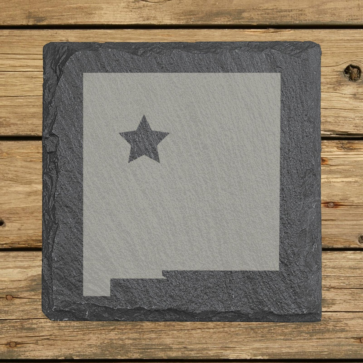 New Mexico square slate coaster engraved with the state shape and a star