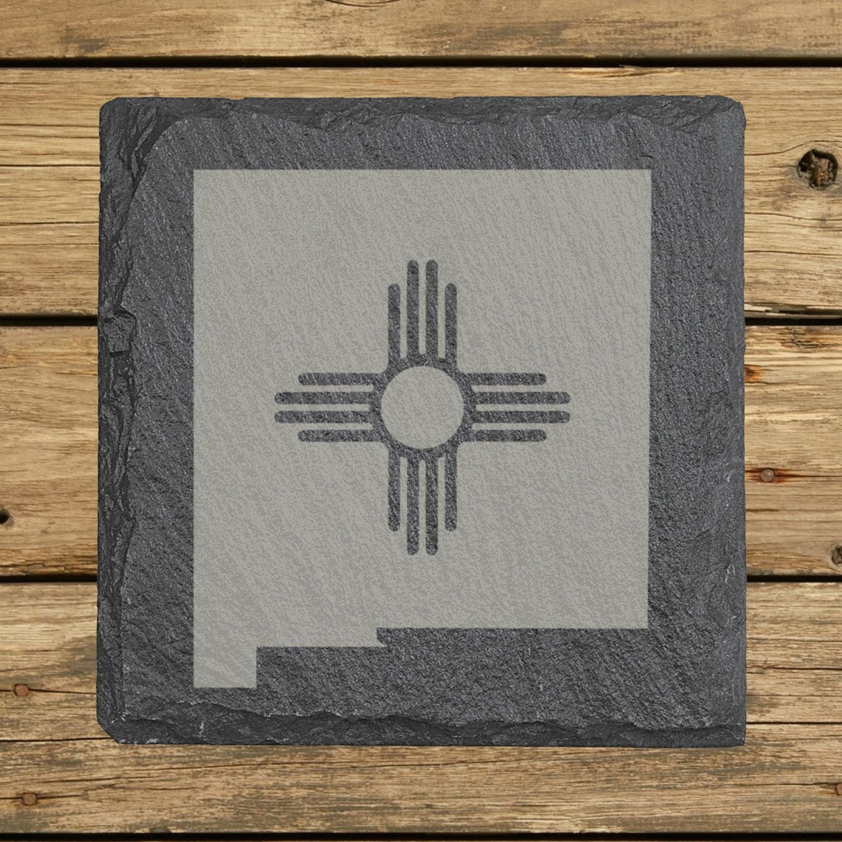 New Mexico square slate coaster engraved with the state shape and the Zia sun symbol