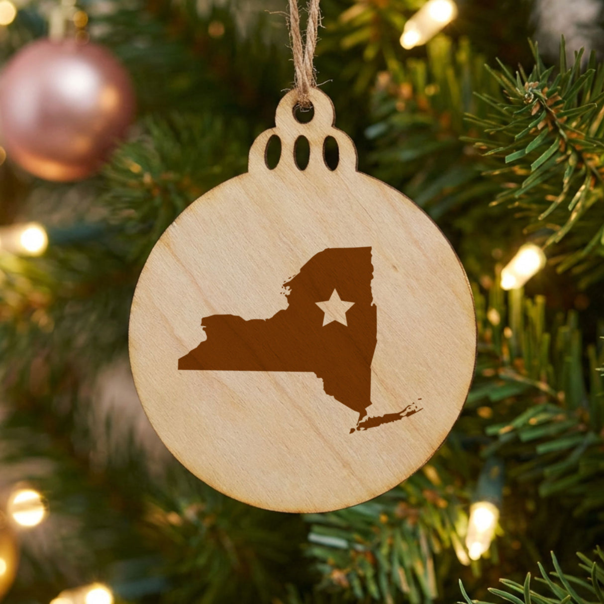 New York round wood Christmas ornament engraved with the state shape and a star