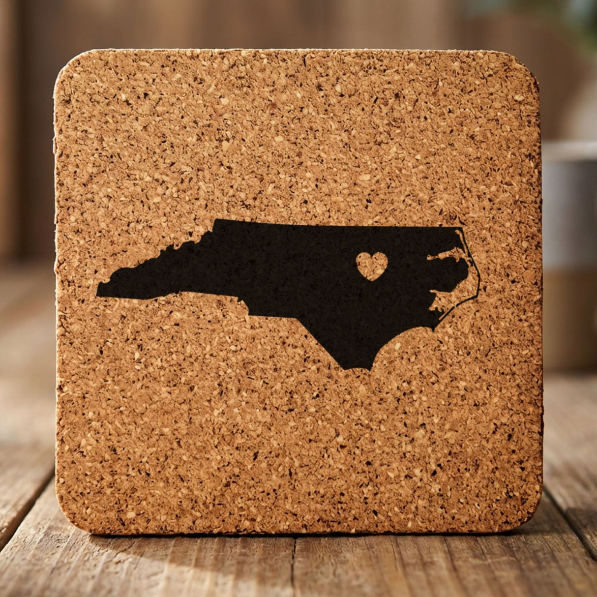 North Carolina square cork coaster engraved with the state shape and a heart
