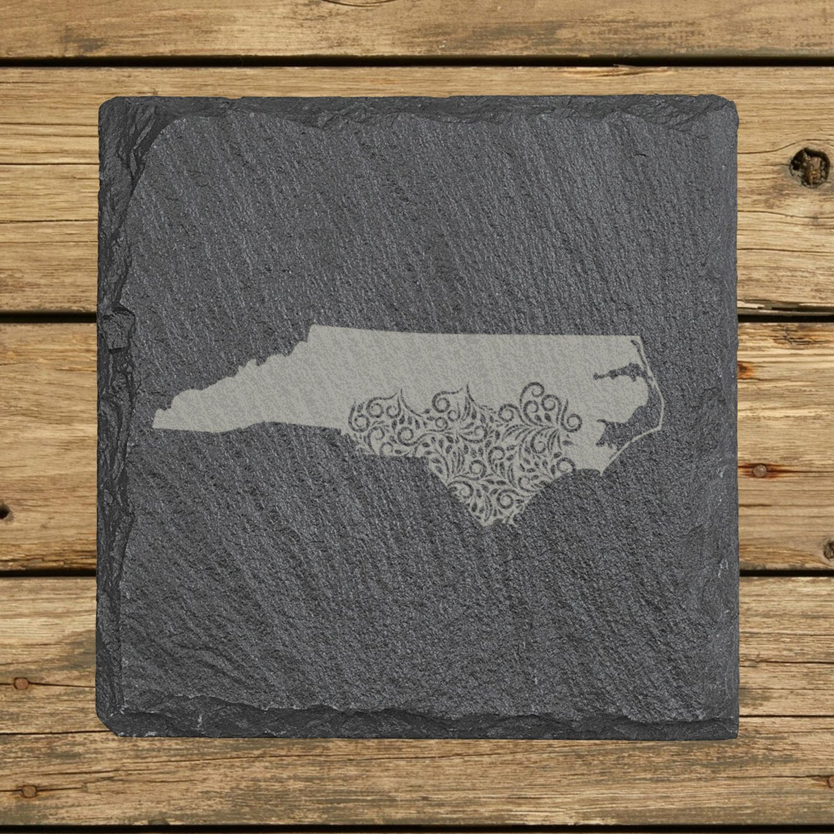 North Carolina square slate coaster engraved with the state shape in ornate floral scrollwork