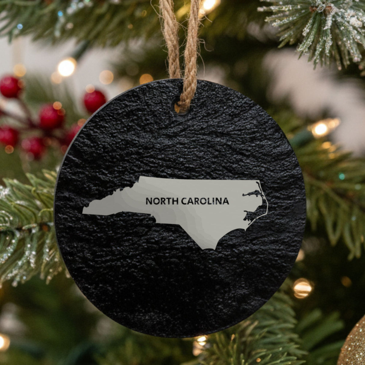 North Carolina round slate Christmas ornament engraved with the state shape and NORTH CAROLINA in bold lettering