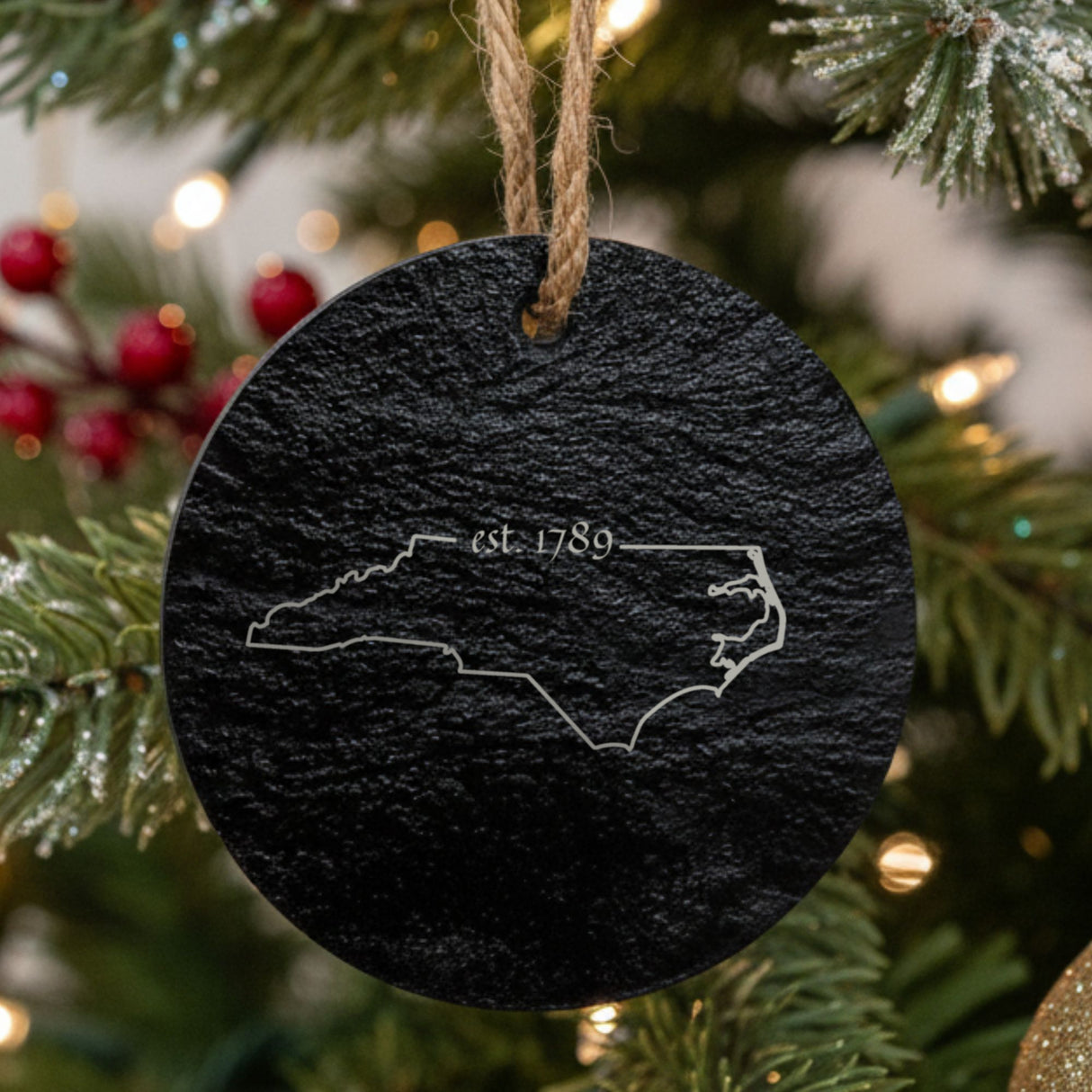 North Carolina round slate Christmas ornament engraved with the state outline and est. 1789