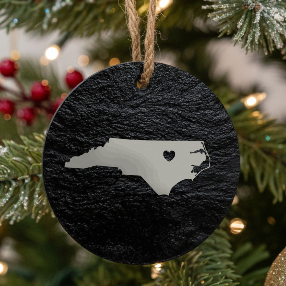 North Carolina round slate Christmas ornament engraved with the state shape and a heart