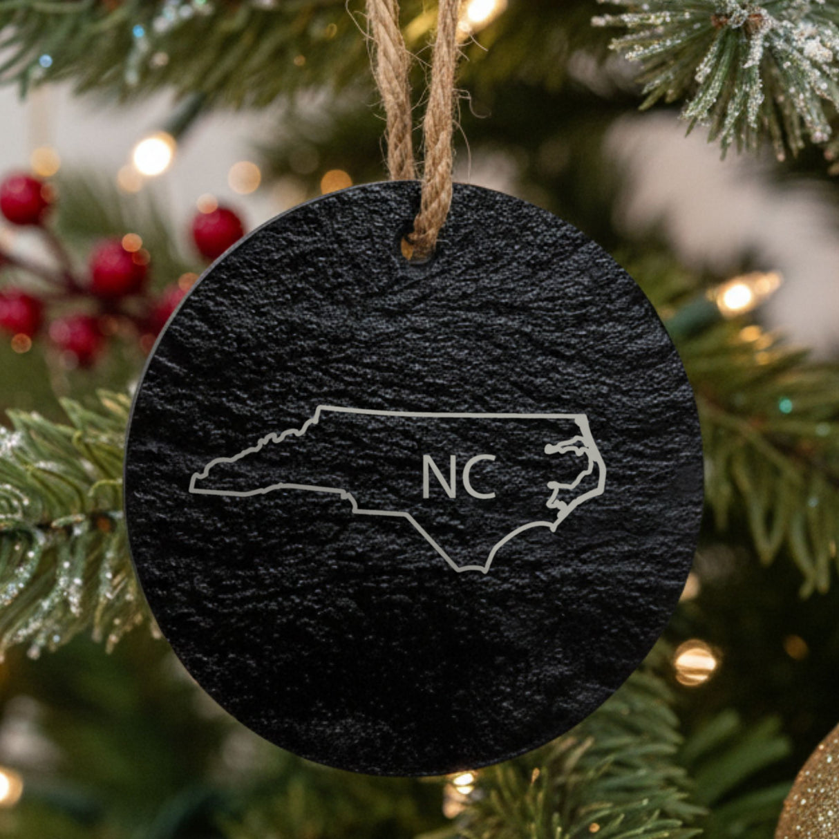 North Carolina round slate Christmas ornament engraved with the state outline and NC initials