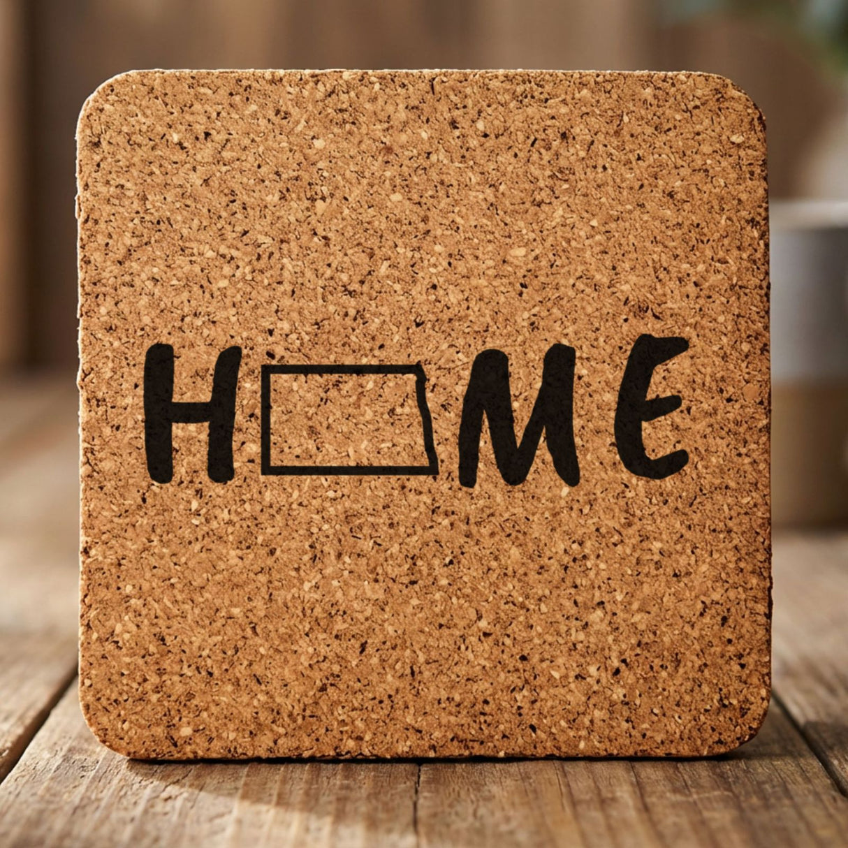 North Dakota square cork coaster engraved with HOME using the state outline as the letter O