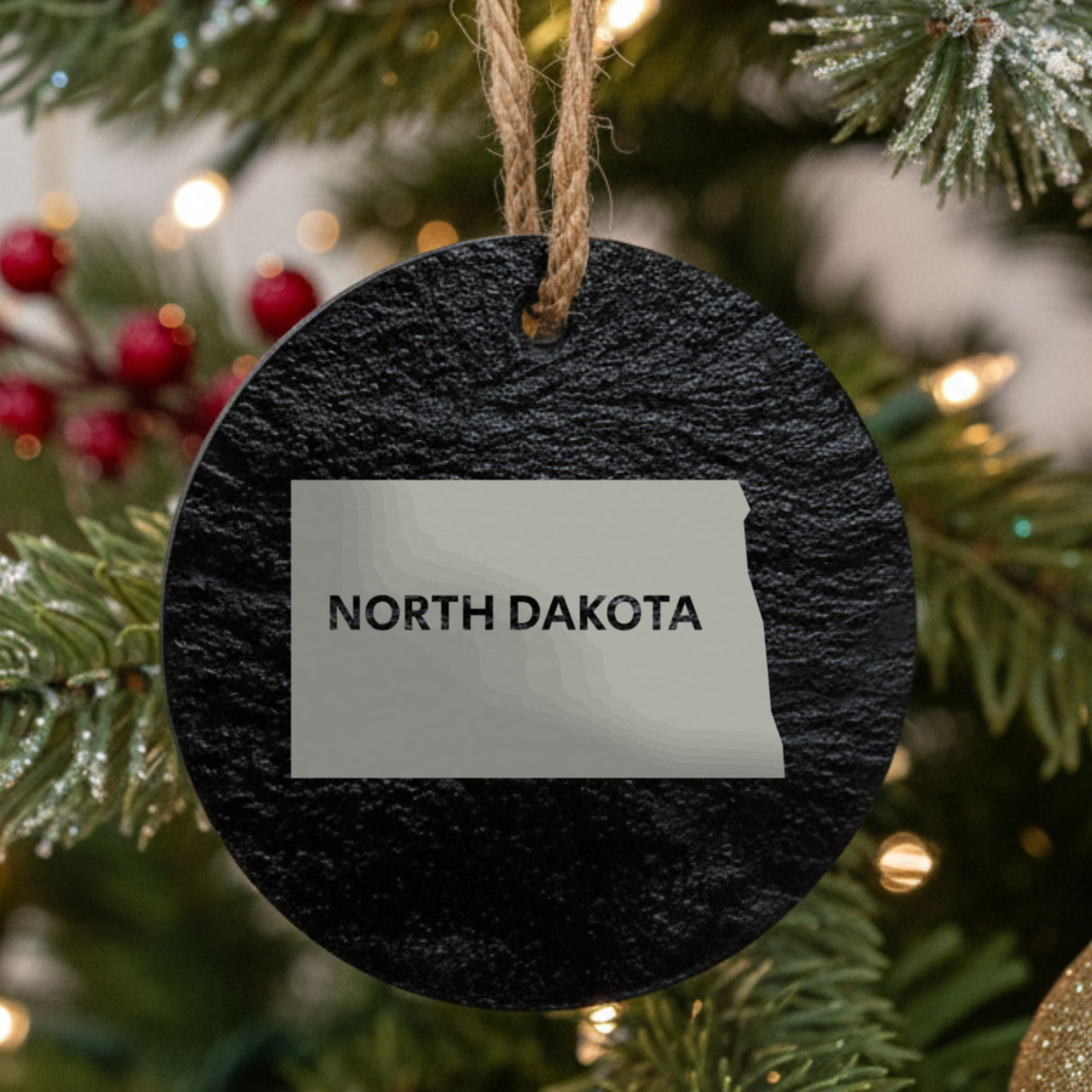 North Dakota round slate Christmas ornament engraved with the state shape and NORTH DAKOTA in bold lettering