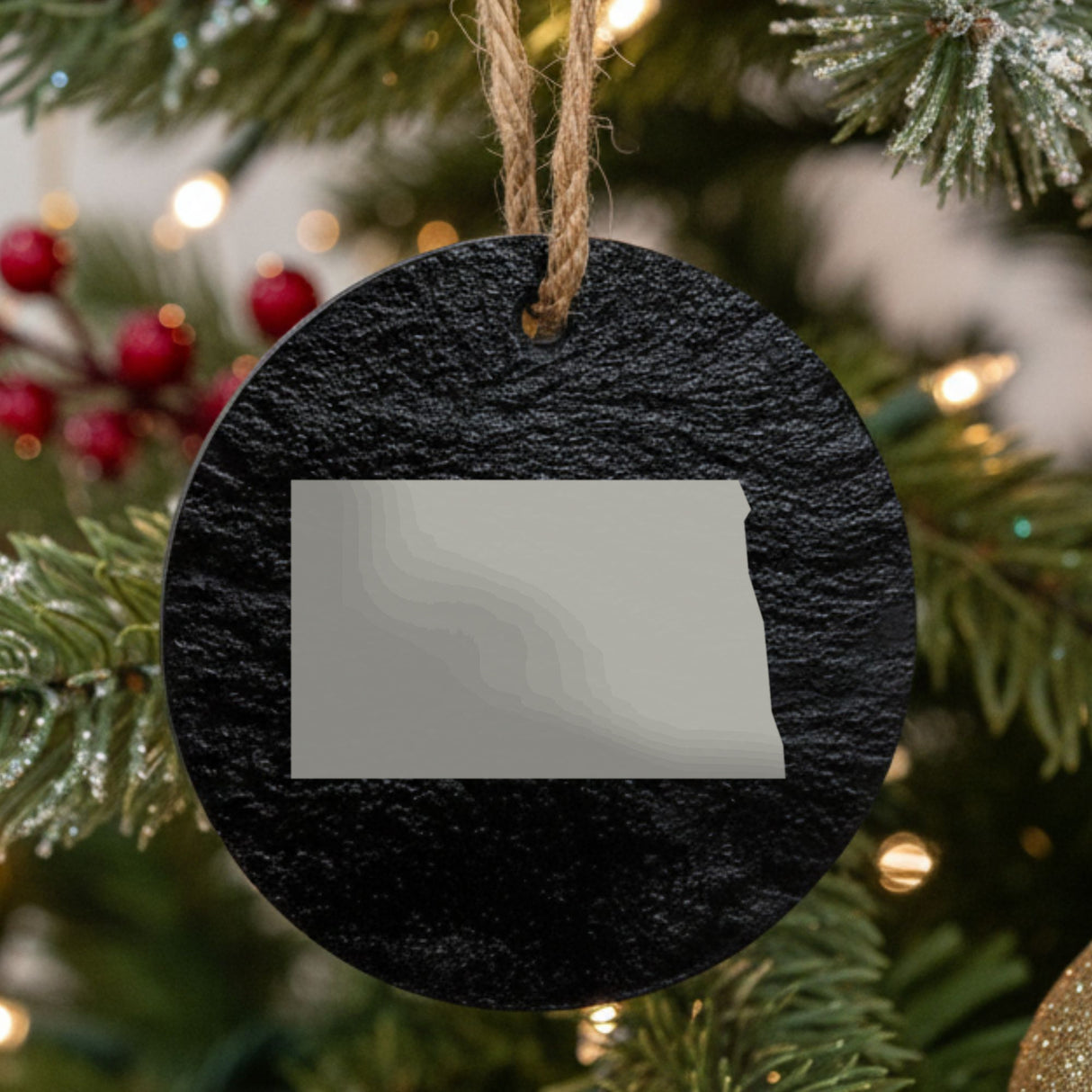 North Dakota round slate Christmas ornament with the full state shape engraved