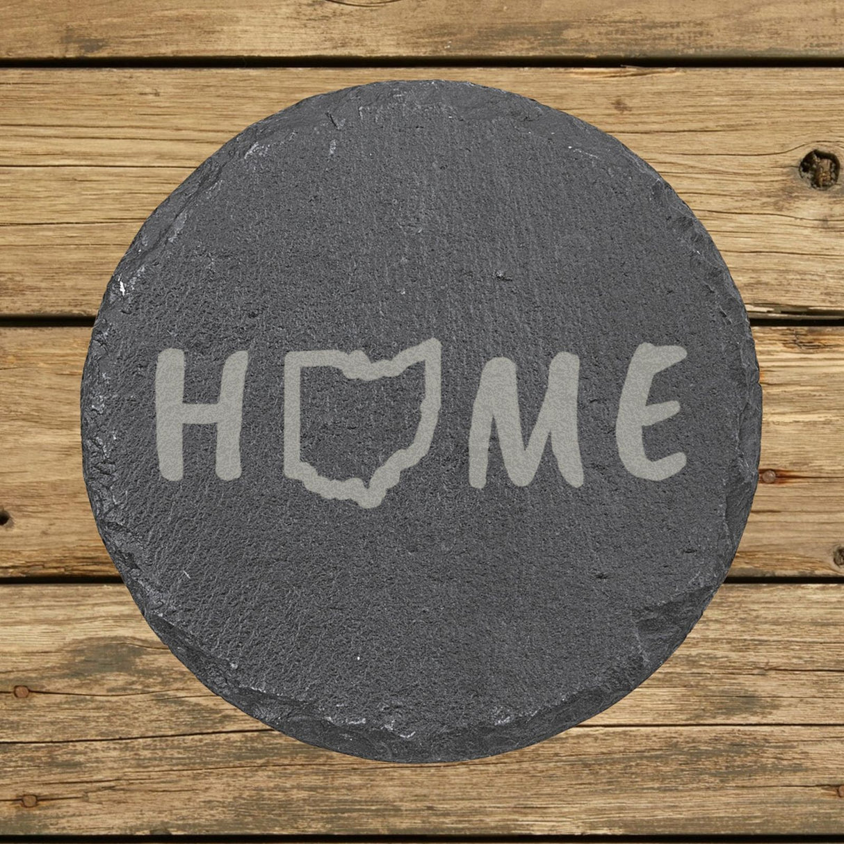 Ohio round slate coaster engraved with HOME using the state outline as the letter O