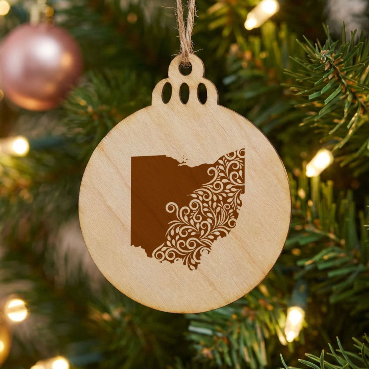 Ohio round wood Christmas ornament engraved with the state shape in ornate floral scrollwork