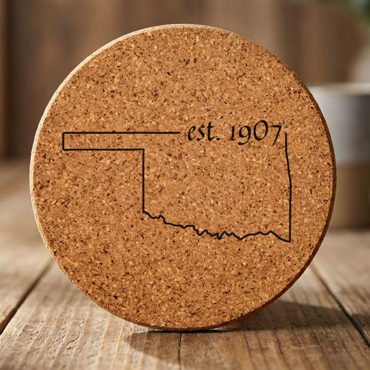 Oklahoma round cork coaster engraved with the state outline and est. 1907