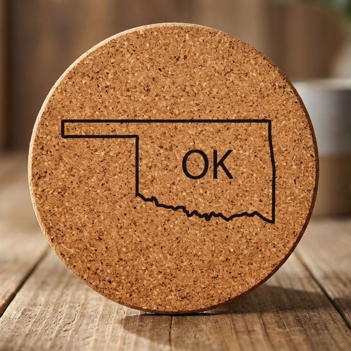Oklahoma round cork coaster engraved with the state outline and OK initials