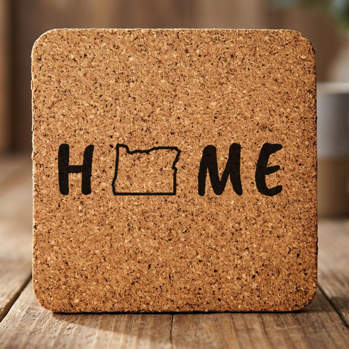 Oregon square cork coaster engraved with HOME using the state outline as the letter O