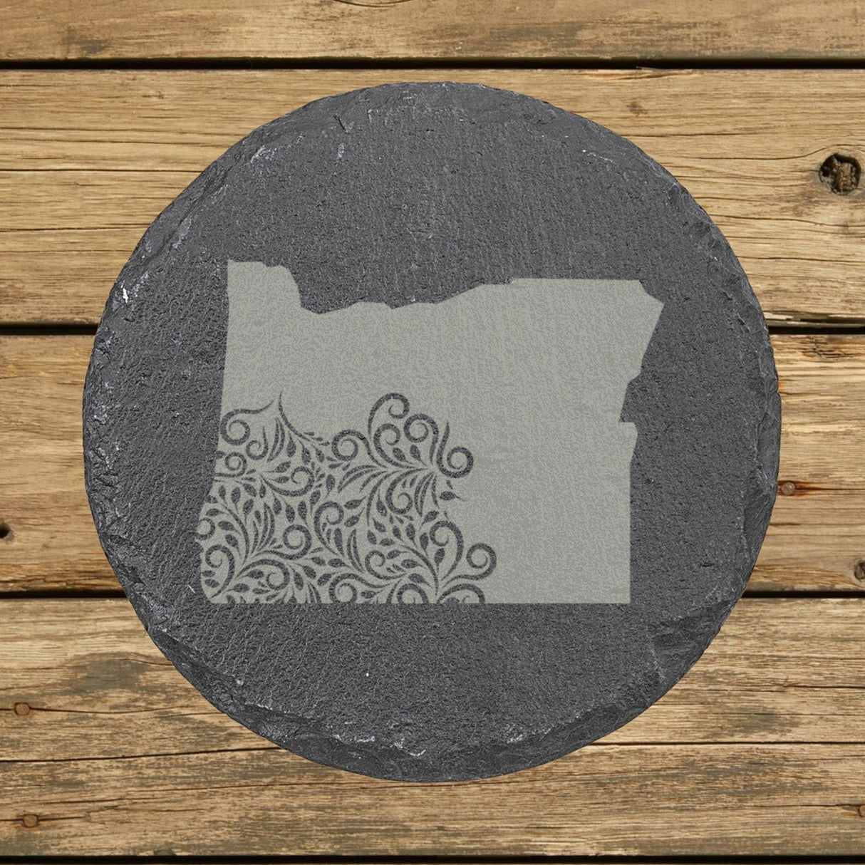 Oregon round slate coaster engraved with the state shape in ornate floral scrollwork