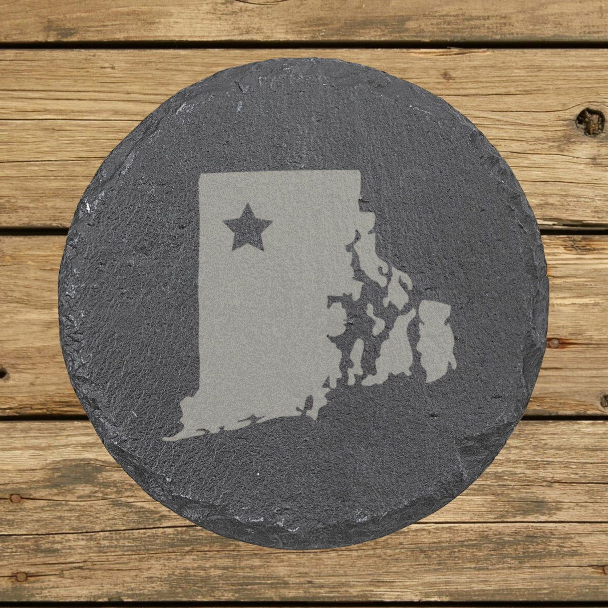Rhode Island round slate coaster engraved with the state shape and a star