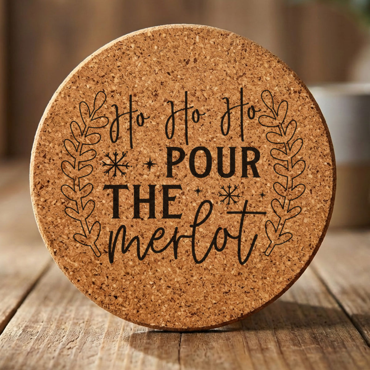 Round cork coaster laser engraved with "Ho Ho Ho Pour the Merlot"