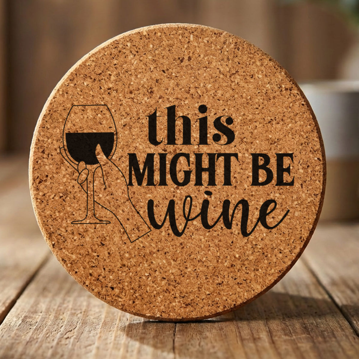 Round cork coaster laser engraved with "This Might Be Wine"