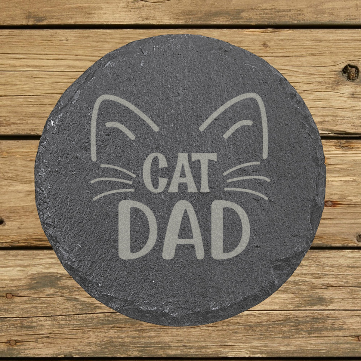 Round slate coaster laser engraved with "Cat Dad", whiskers design