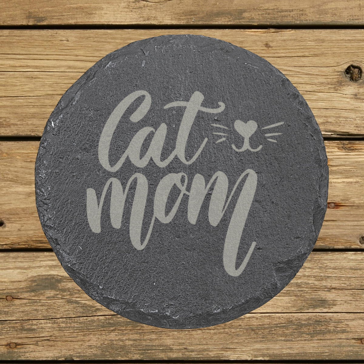 Round slate coaster laser engraved with "Cat Mom", whiskers design