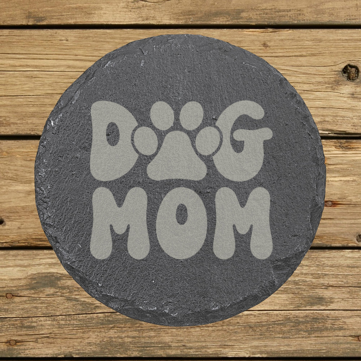 Round slate coaster laser engraved with a retro bubble letter Dog Mom design with a paw print