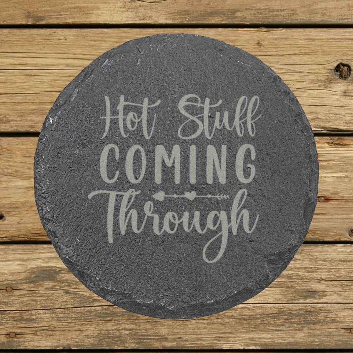 Round slate coaster laser engraved with "Hot Stuff Coming Through"