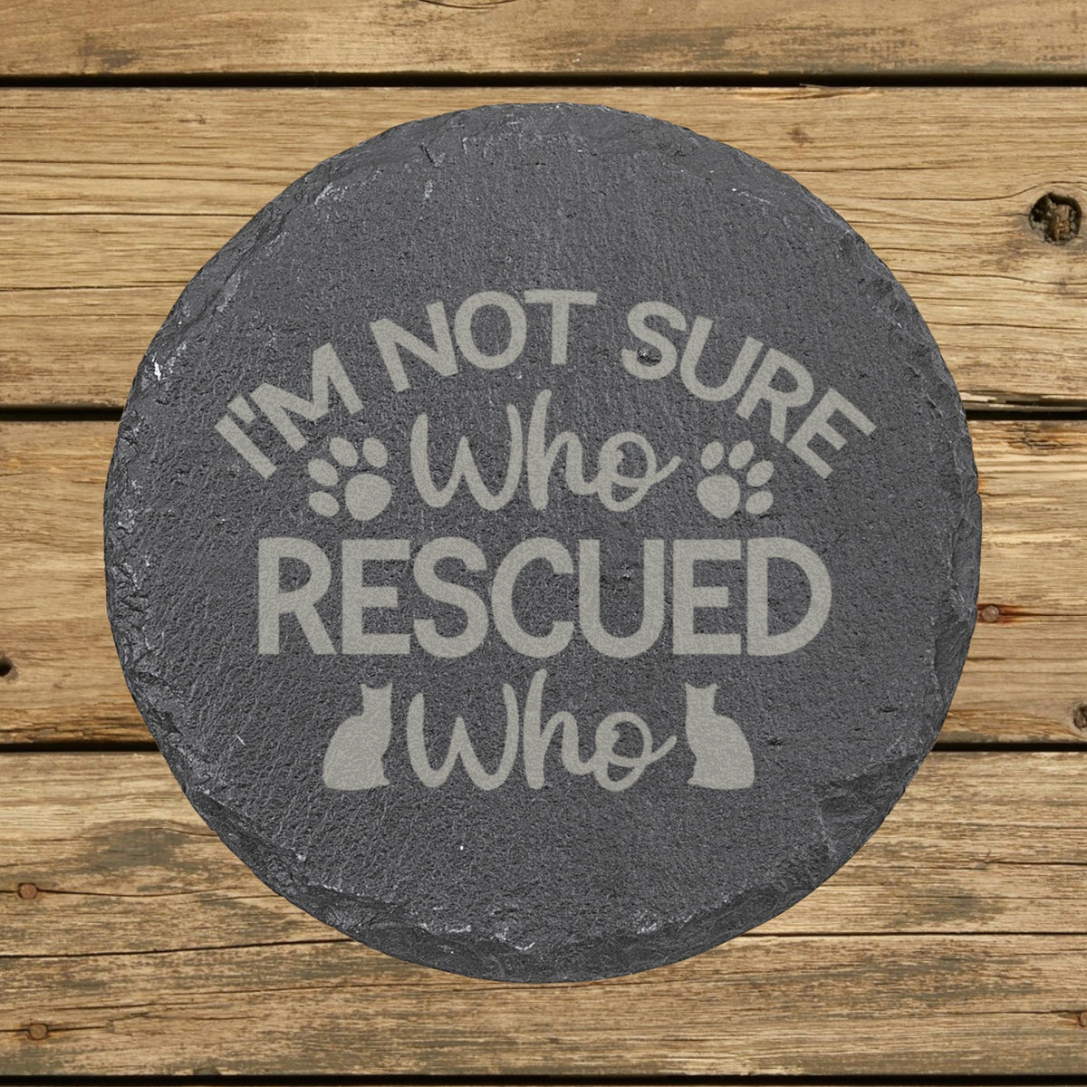 Round slate coaster laser engraved with "I'm Not Sure Who Rescued Who"