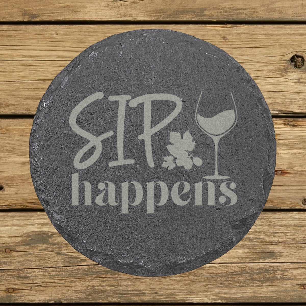 Round slate coaster laser engraved with "Sip Happens"