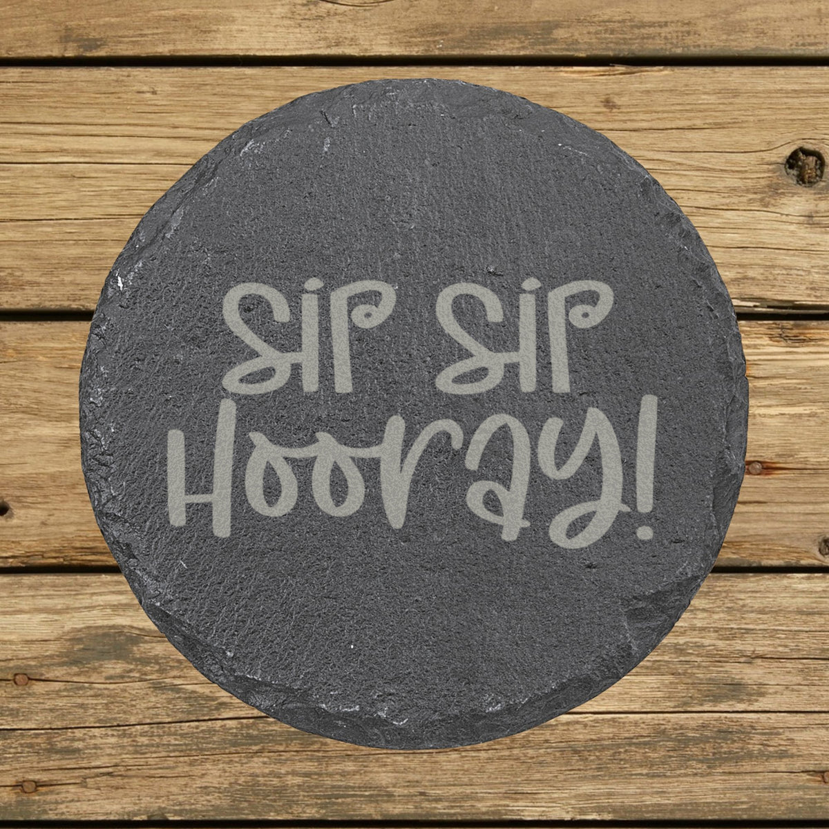 Round slate coaster laser engraved with "Sip Sip Hooray"