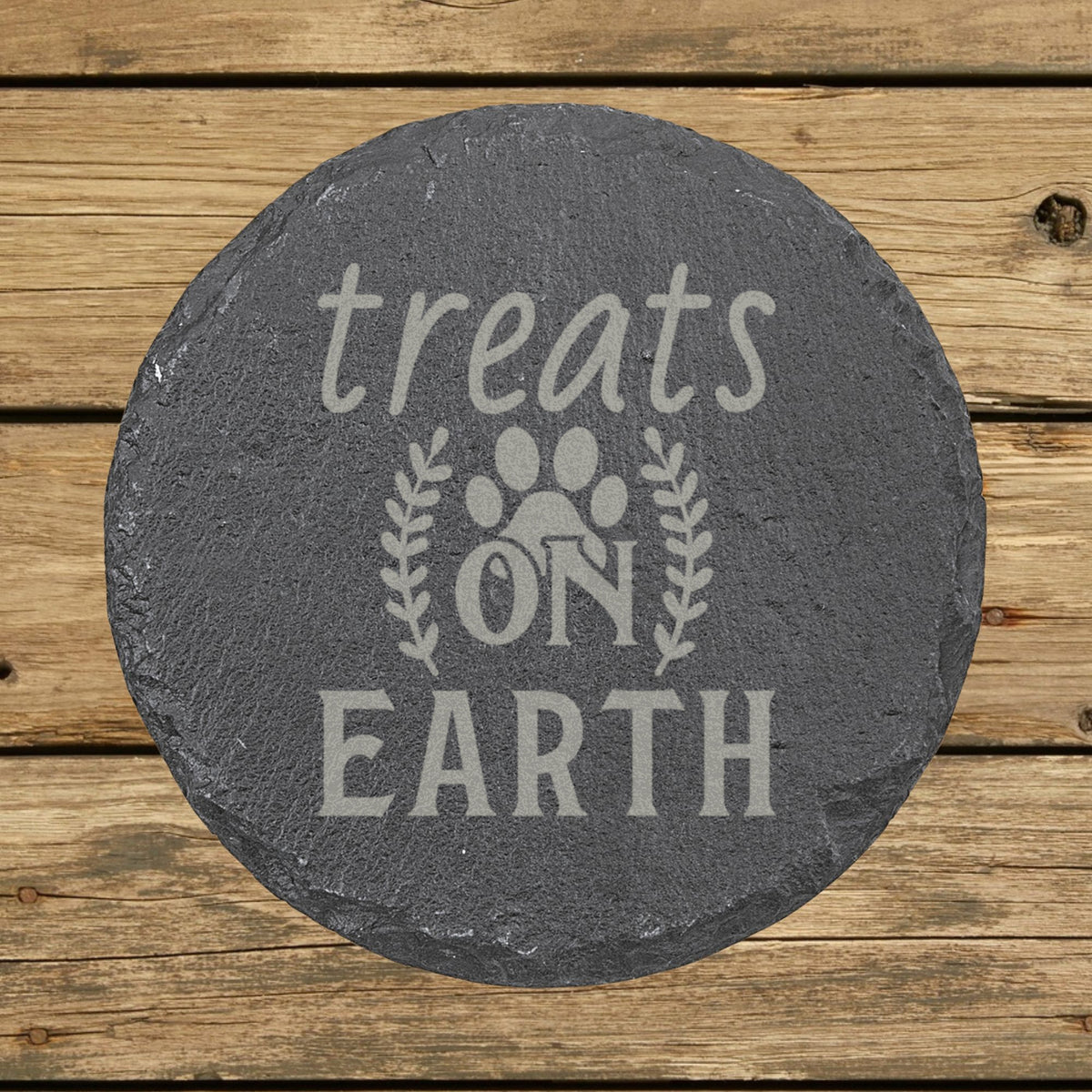 Round slate coaster laser engraved with "Treats on Earth"