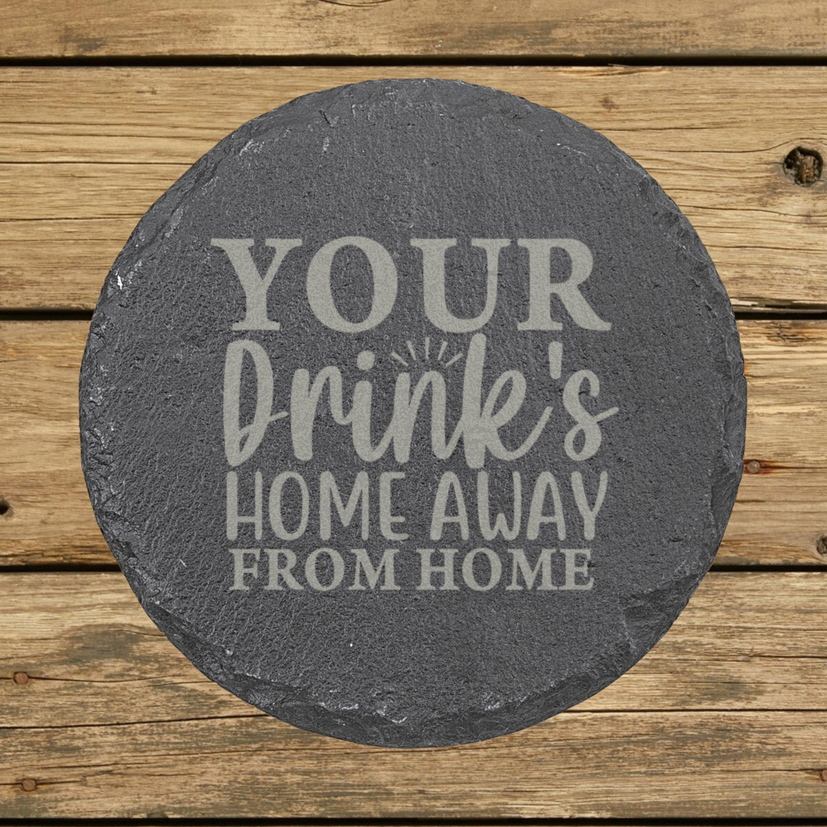 Round slate coaster laser engraved with "Your Drink's Home Away From Home"