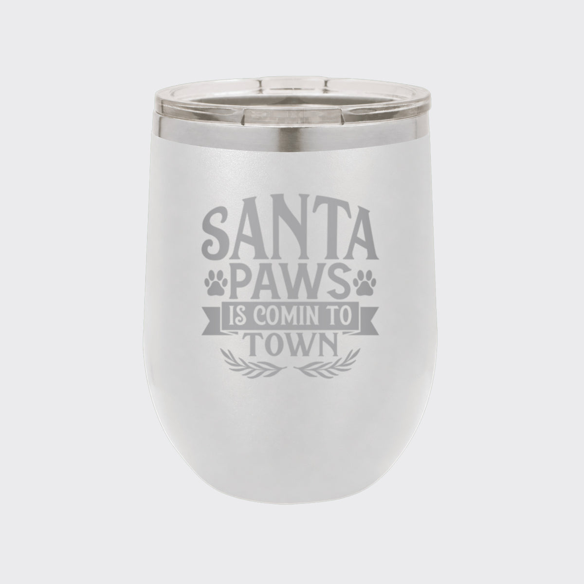 White 12 oz stemless wine tumbler laser engraved with "Santa Paws Is Comin' to Town"